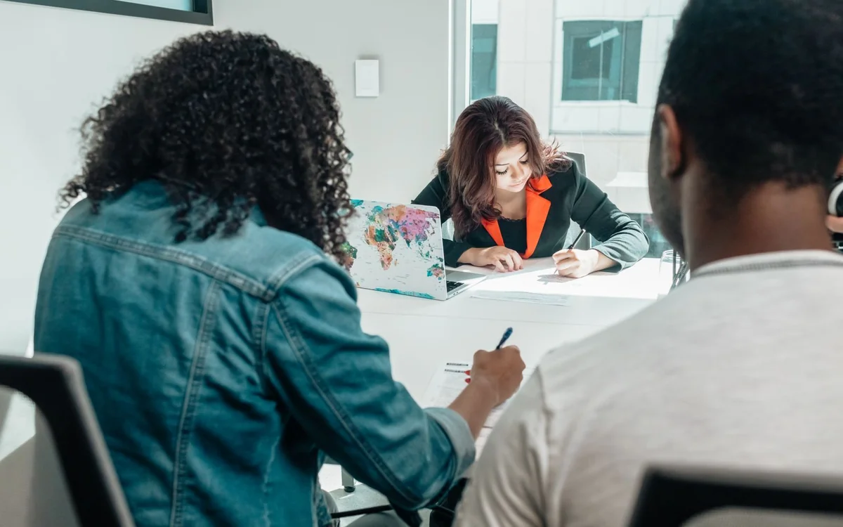 Team completing paperwork together during a business meeting